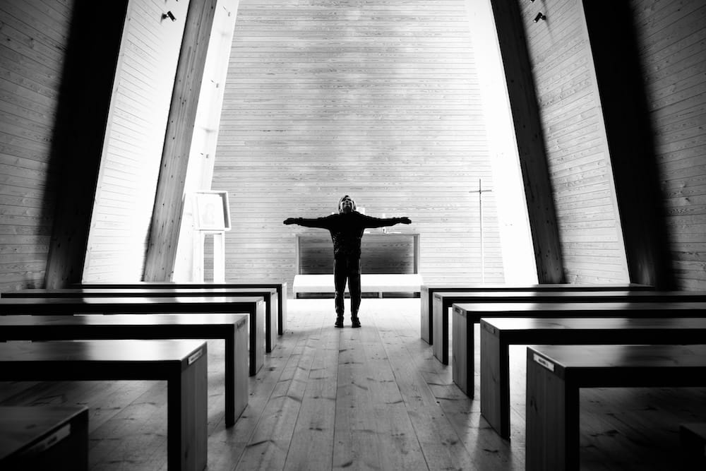 BW image of a boy in a church.